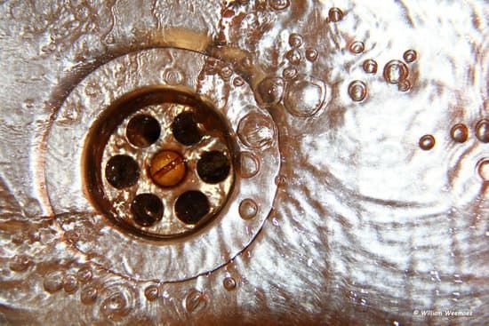 A clean drain with water going down it